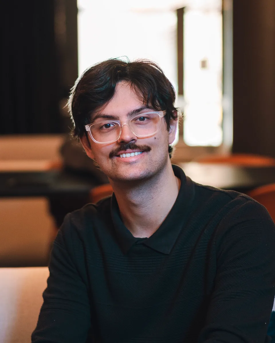 Ethan Mehta seated and smiling